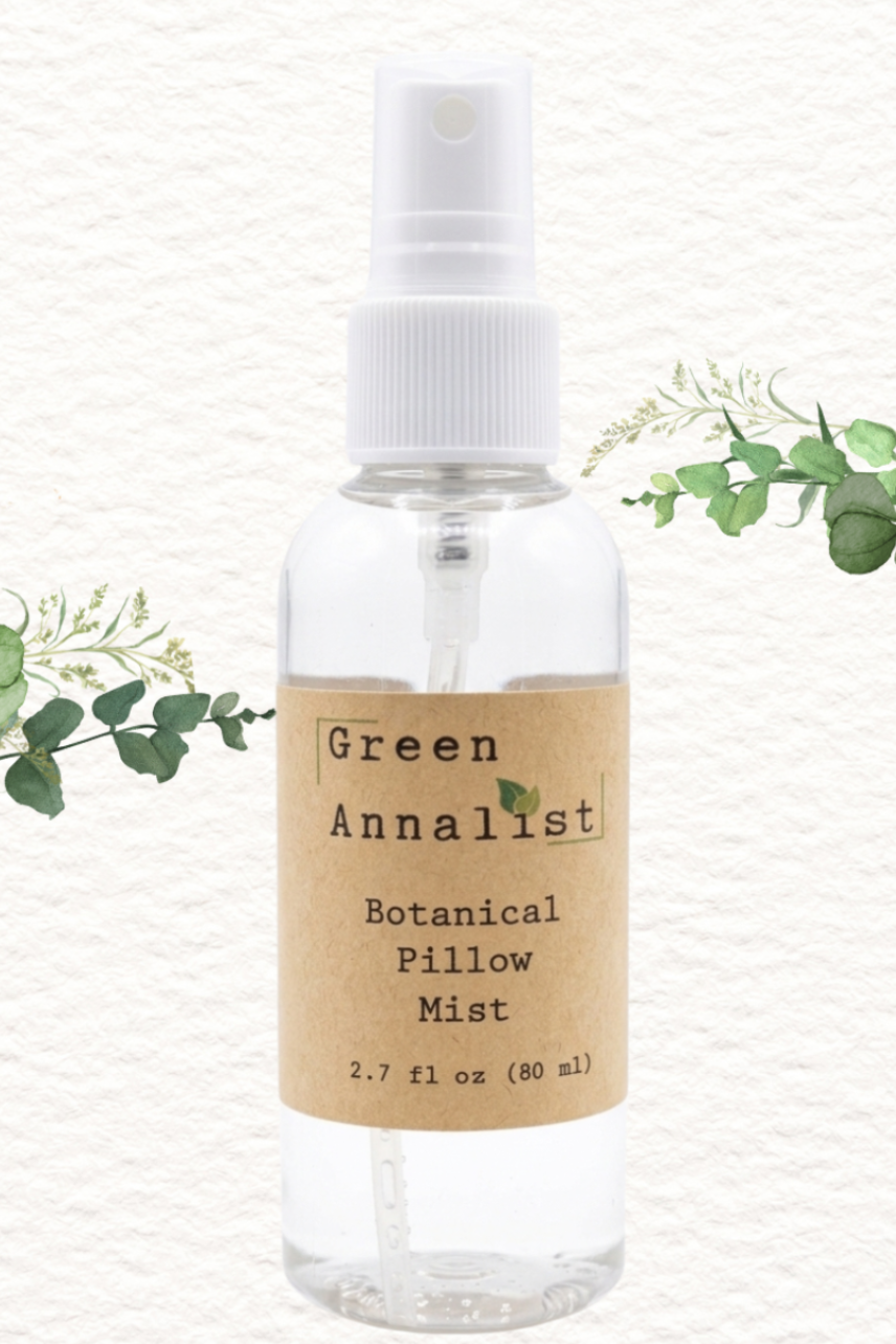 Clear spray bottle labeled 'Green Annalist Botanical Pillow Mist' with a white cap on a light gray background.